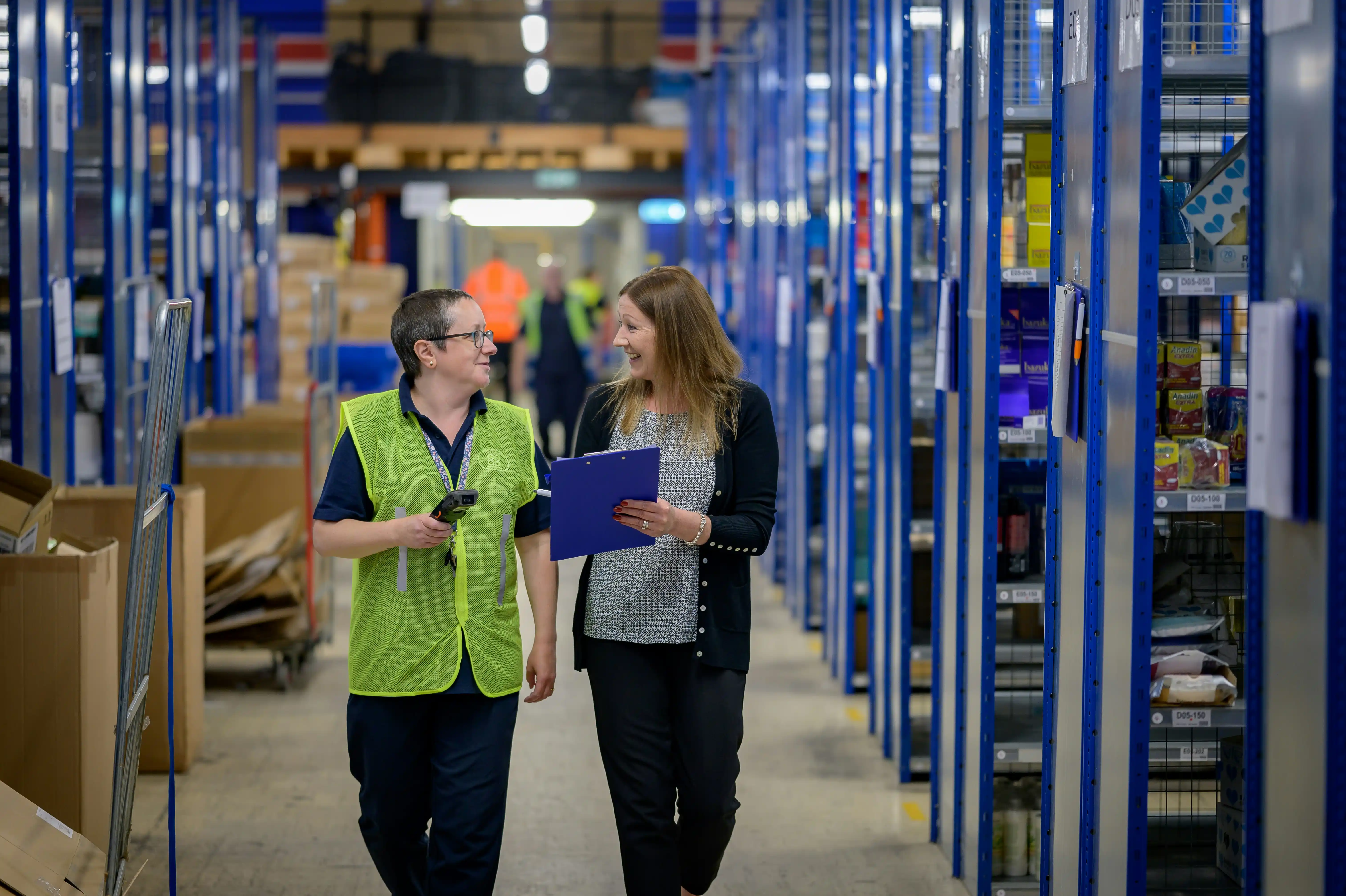 Warehouse staff reviewing delivery planning and package tracking